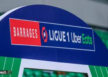 Signboard on a blue stadium arch reading 'BARRAGES' and 'LIGUE 1 Uber Eats' with red and green highlights