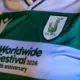 Close-up of a green and white striped soccer jersey with the sponsor text 'Worldwide Festival 2026, 20th anniversary' and a crest on the chest.