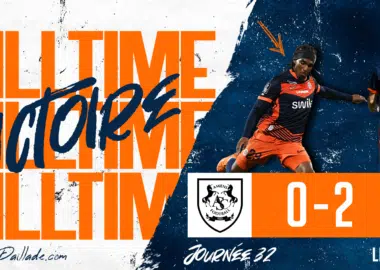 Banner announcing full-time victory: score 0-2 with team crests on an orange band and players in orange and navy kits.