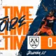 Banner announcing full-time victory: score 0-2 with team crests on an orange band and players in orange and navy kits.