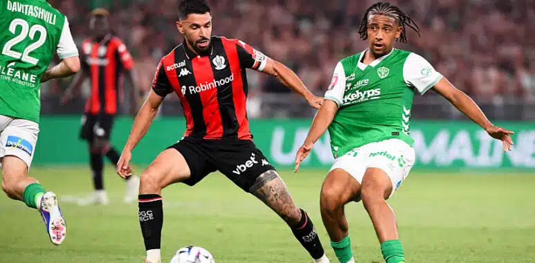 AS Saint Etienne Sanson v OGC Nice - Ligue 1 McDonalds 20252026 - RelegationPromotion Playoffs | AllezPaillade.com Two soccer players contesting the ball during a match; one wears red-and-black stripes, the other green-and-white kit, in a crowded stadium.