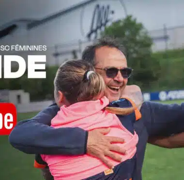 A man hugging a young girl and a female footballer on a grassy field, with YouTube and 'INSIDE' branding in white text above, suggesting a video feature.