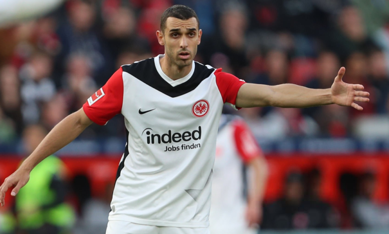 Soccer player in an Eintracht Frankfurt jersey with arms outstretched during a match? on the field