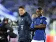 Olivier GIROUD Mapou YANGAMBIWA | AllezPaillade.com Two male soccer players stand side by side on the pitch, one in a blue striped France jersey and the other in a dark training jacket, smiling at the camera.