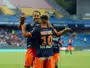 Boudebouz #10 celebrating with a teammate on the soccer field in blue and orange kit.