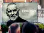 Large outdoor billboard featuring a black-and-white portrait of Eric Roy, with the text '1967-2026 ERIC ROY Uno di moi' on a gray background.