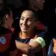Women&rsquo;s soccer team celebrates, central player smiles while teammates hug.