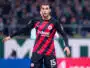 Soccer player in Eintracht Frankfurt kit with number 15, standing near the goal during a match.