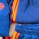 Instagram story announcing Montpellier Football Club new training fits, shown on a person wearing a blue training suit with orange stripes.