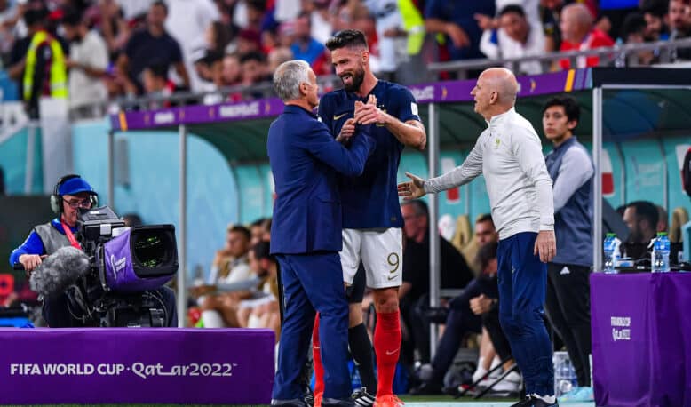 France v Poland - FIFA World Cup 2022 Round of 16 | AllezPaillade.com Soccer players shake hands on the sideline during a FIFA World Cup match (Qatar 2022), with a cameraman filming nearby.