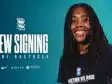 IMG_5276 | AllezPaillade.com Smiling woman with dreadlocks in a navy shirt against a teal background, large 'NEW SIGNING' text and team logos nearby.