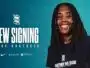 Smiling woman with dreadlocks in a navy shirt against a teal background, large 'NEW SIGNING' text and team logos nearby.