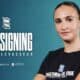 New signing announcement: Marie Levasseur against a teal backdrop with sponsor logos and text 'Together We Rise' on her shirt.