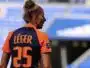 Soccer player seen from behind wearing an orange and navy jersey with the name L&Eacute;GER and number 25 on the back, in a stadium.