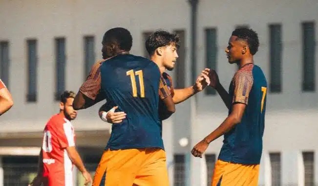 Prépa | AllezPaillade.com Two soccer players celebrate together on the field, wearing blue jerseys and orange shorts, with the number 11 on one player's back.