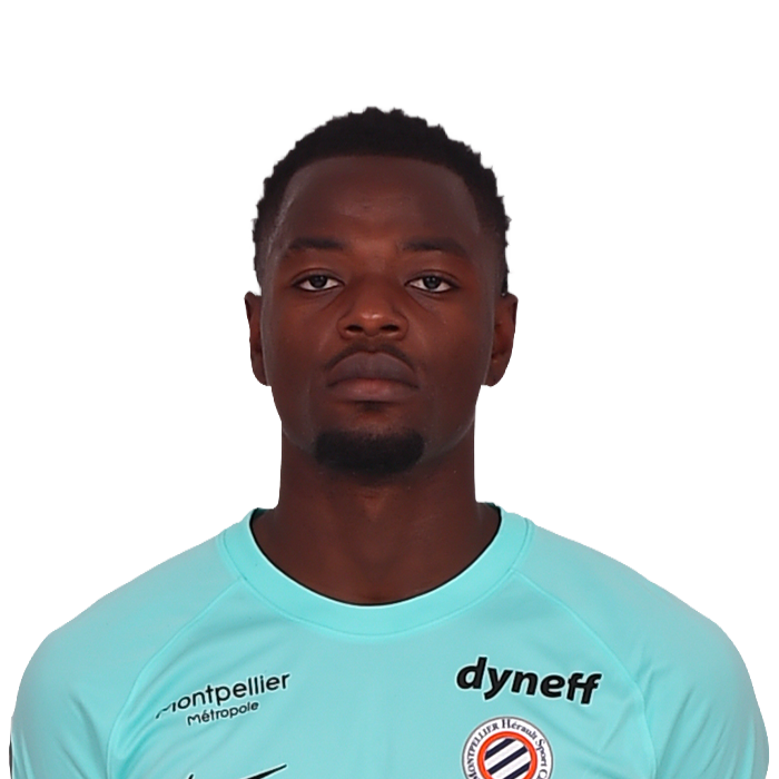 Portrait of a Black male soccer player in a light blue jersey with sponsor logos (Dyneff, FAUN) and a club badge, facing the camera with a neutral expression.