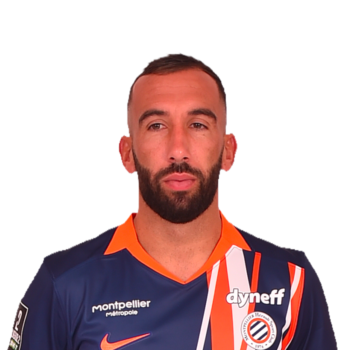 5-tardieu | AllezPaillade.com Portrait of a male soccer player with short dark hair and beard, wearing a dark blue and orange jersey with a club badge and sponsor logos, against a pale pink background.