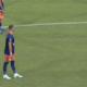 Soccer players in blue and orange uniforms stand near the center line; ball sits on the field as a 0-0 scoreboard and timer appear on screen (00:22) with a beIN SPORTS logo.