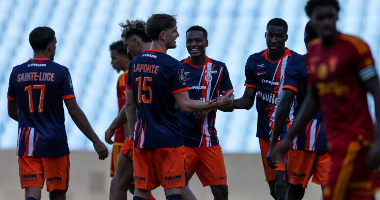 Laporte Mamadou Camara Montpellier Herault SC v Rodez Aveyron Football - Friendly Match 01082026 | AllezPaillade.com Group of young soccer players in blue and orange jerseys greet each other with handshakes and smiles on a grassy field.
