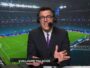 Sports commentator in a suit and headset speaks into a microphone in a stadium, name visible as Guillaume Palacios.
