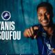 Promotional banner: smiling player in blue pinstripe jersey pointing at the camera with Millwall crest and the text 'YANIS ISSOUFOU' on a teal backdrop; 'WELCOME TO MILLWALL' unreadable at top-right.